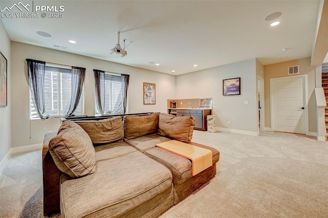 living room featuring light colored carpet, baseboards, and recessed lighting