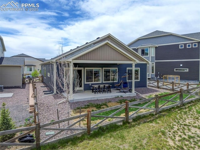 rear view of property with a patio and a fenced backyard