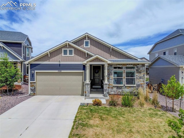 craftsman-style home with stone siding, an attached garage, concrete driveway, and board and batten siding