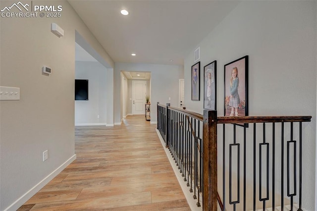 corridor with recessed lighting, baseboards, and light wood finished floors