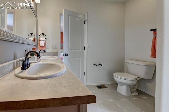 7367 Cornice Pt, Colorado Springs, CO 80923 - bathroom featuring tile patterned flooring, baseboards, toilet, and double vanity