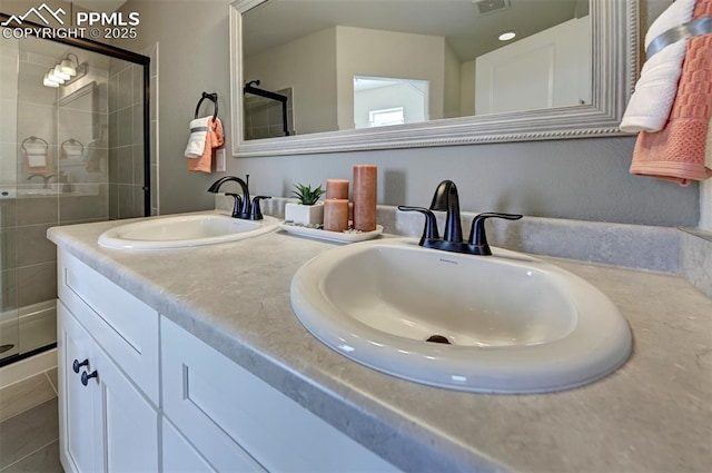 7367 Cornice Pt, Colorado Springs, CO 80923 - bathroom featuring a shower stall and double vanity