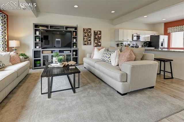 7367 Cornice Pt, Colorado Springs, CO 80923 - living area with light wood finished floors, recessed lighting, and beam ceiling