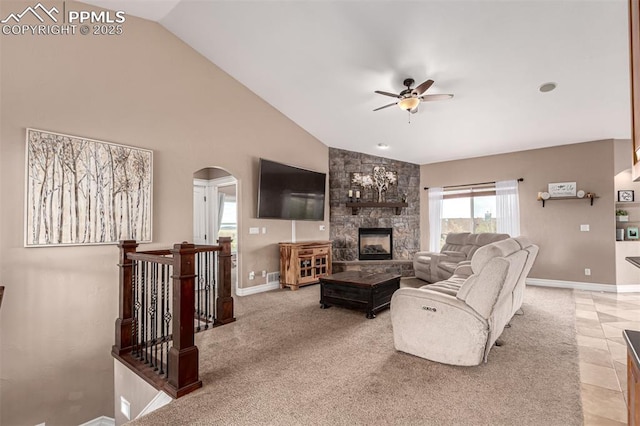 20097 Royal Troon Dr, Monument, CO 80132 - living room with a ceiling fan, arched walkways, baseboards, a fireplace, and high vaulted ceiling