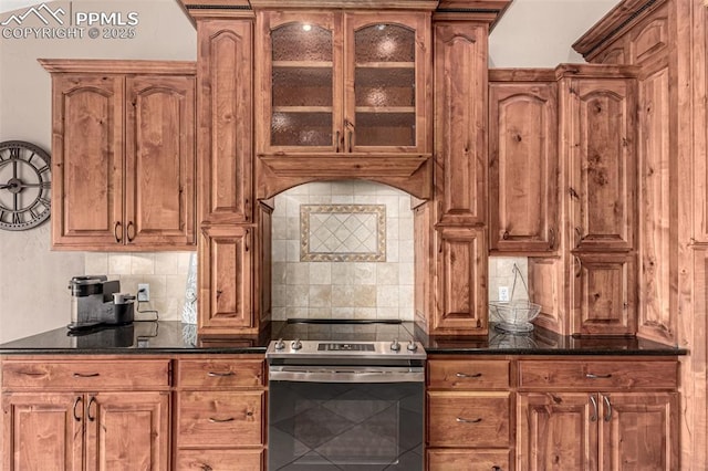 20097 Royal Troon Dr, Monument, CO 80132 - kitchen featuring stainless steel electric range, backsplash, glass insert cabinets, and brown cabinetry