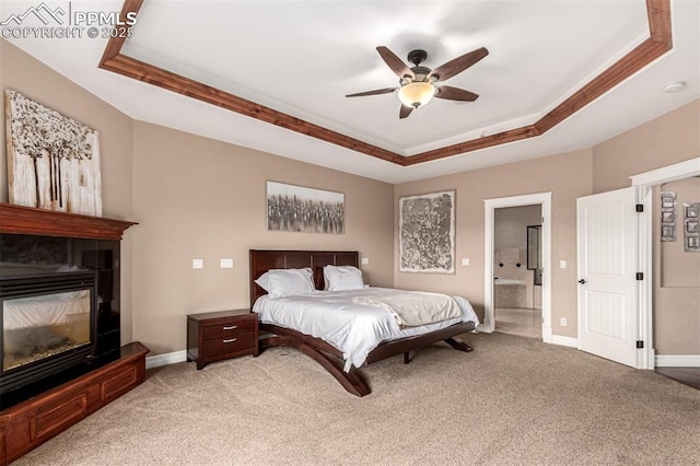 20097 Royal Troon Dr, Monument, CO 80132 - bedroom featuring a raised ceiling, light carpet, and baseboards