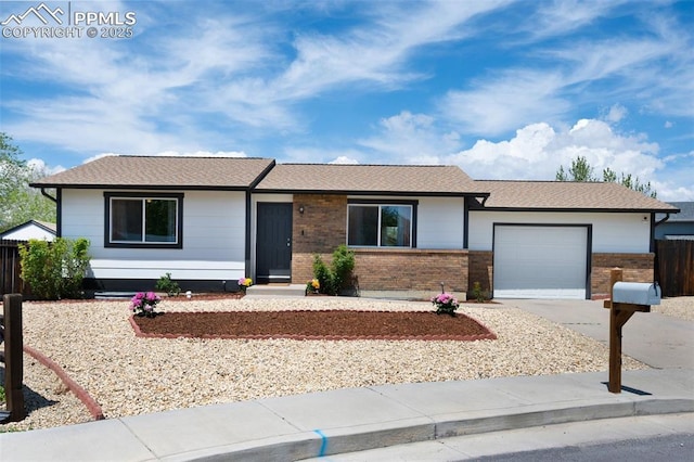 ranch-style house featuring a garage, concrete driveway, brick siding, fence, and roof with shingles