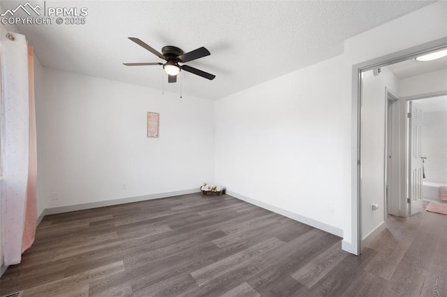 empty room featuring ceiling fan, wood finished floors, and baseboards