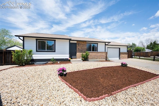 ranch-style house with concrete driveway, a garage, fence, and brick siding