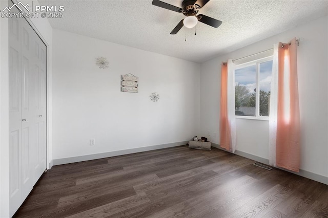 unfurnished bedroom with wood finished floors, a textured ceiling, a closet, a ceiling fan, and baseboards