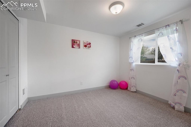 unfurnished room featuring carpet flooring and baseboards