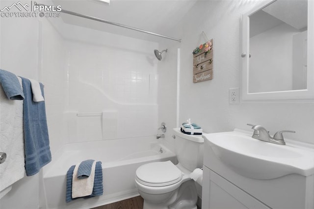bathroom featuring toilet, vanity, shower / washtub combination, and wood finished floors