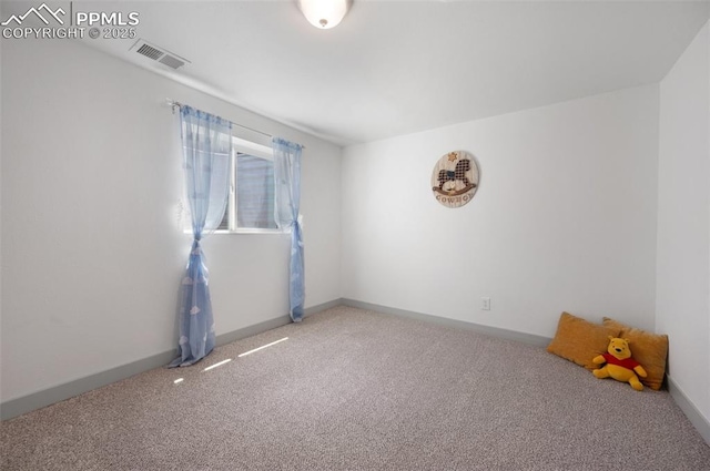 empty room with carpet and baseboards