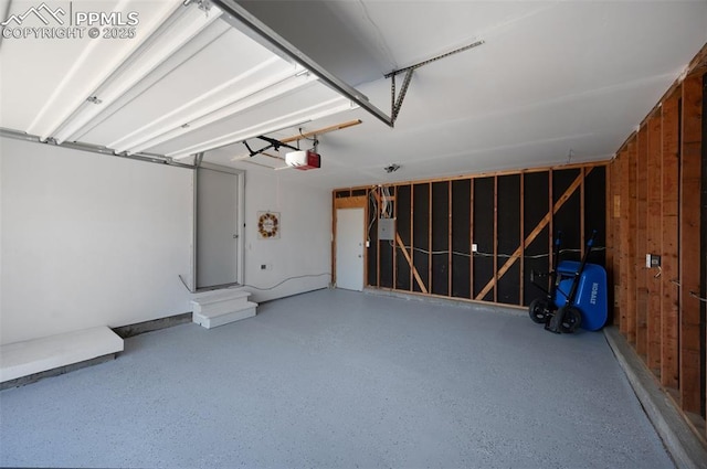 garage featuring a garage door opener and wooden walls