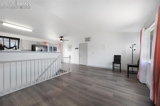 unfurnished room with dark wood finished floors, ceiling fan, and baseboards