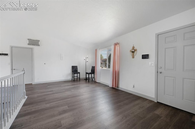 empty room with wood finished floors and baseboards