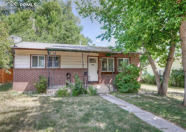1036 Florence Ave, Colorado Springs, CO 80905 - view of front of house featuring brick siding, a front yard, and covered porch