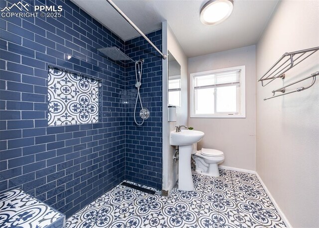 1036 Florence Ave, Colorado Springs, CO 80905 - full bath featuring tiled shower, toilet, and baseboards