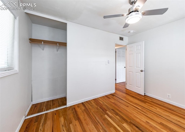 1036 Florence Ave, Colorado Springs, CO 80905 - unfurnished bedroom with baseboards, wood finished floors, a closet, and multiple windows