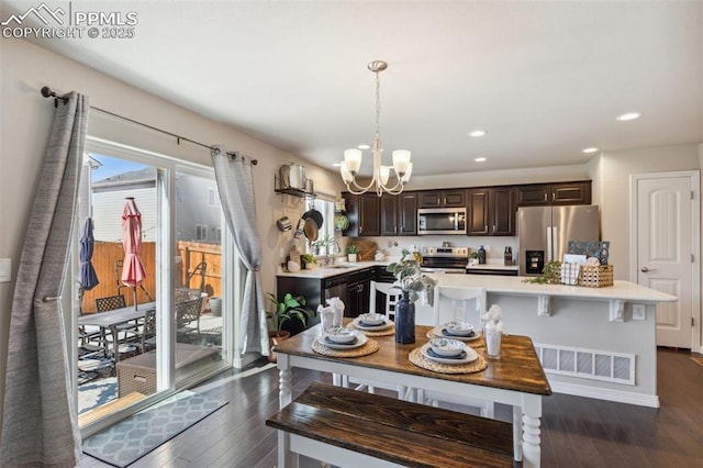 dining room featuring a chandelier, dark wood-style flooring, and recessed lighting