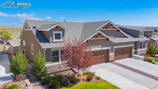 4479 Hessite Loop, Colorado Springs, CO 80938 - view of front of home featuring stucco siding, stone siding, driveway, fence, and a shingled roof