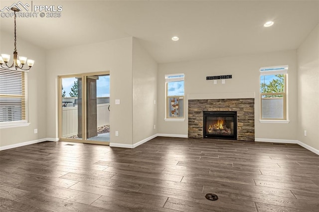 4479 Hessite Loop, Colorado Springs, CO 80938 - unfurnished living room with a chandelier, dark wood-style flooring, baseboards, a stone fireplace, and recessed lighting