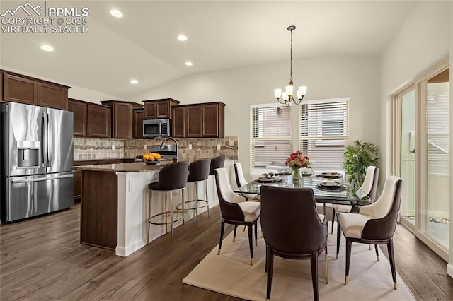 4479 Hessite Loop, Colorado Springs, CO 80938 - dining room featuring vaulted ceiling, a chandelier, dark wood finished floors, and recessed lighting
