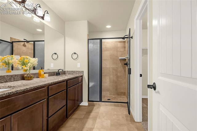 4479 Hessite Loop, Colorado Springs, CO 80938 - full bathroom with a stall shower, double vanity, tile patterned floors, recessed lighting, and baseboards