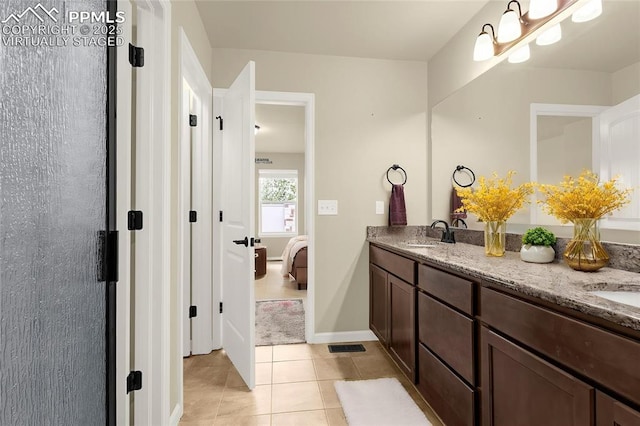 4479 Hessite Loop, Colorado Springs, CO 80938 - bathroom featuring tile patterned floors, double vanity, baseboards, and ensuite bathroom