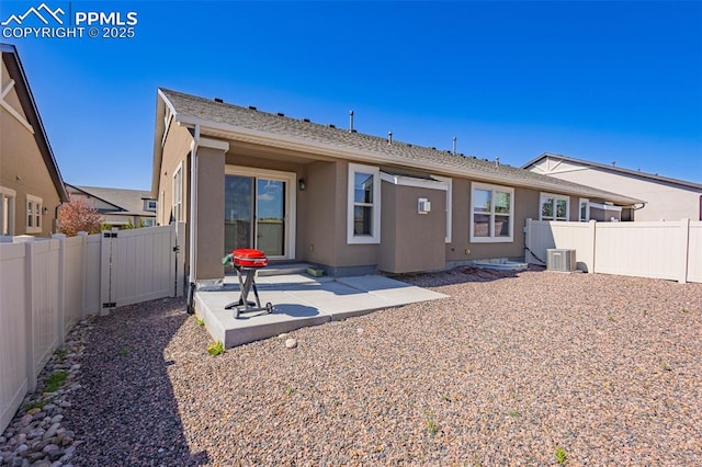 4473 Hessite Loop, Colorado Springs, CO 80938 - back of property featuring a fenced backyard, a patio, stucco siding, and central AC unit