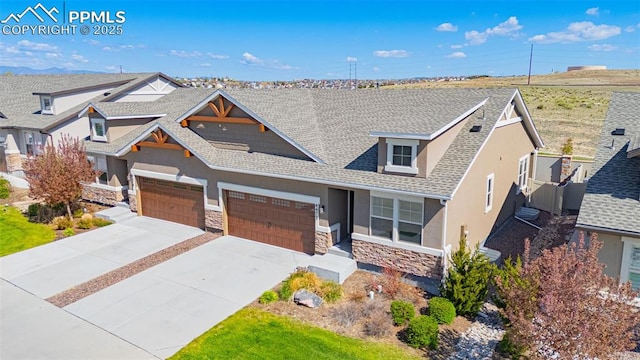 4473 Hessite Loop, Colorado Springs, CO 80938 - view of front of home with stucco siding, stone siding, roof with shingles, an attached garage, and concrete driveway