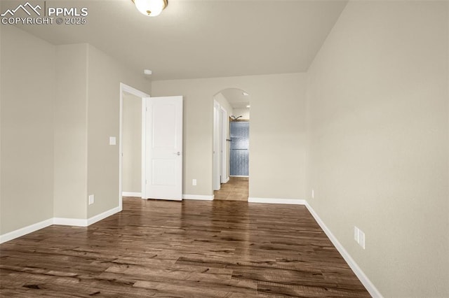 4473 Hessite Loop, Colorado Springs, CO 80938 - unfurnished room featuring arched walkways, wood finished floors, and baseboards