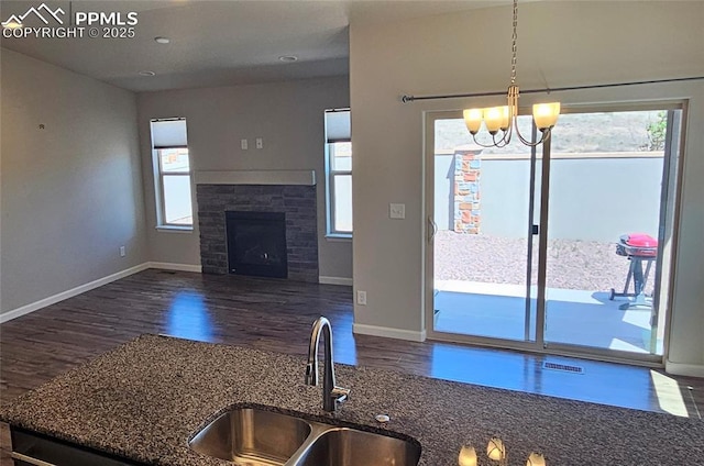 4473 Hessite Loop, Colorado Springs, CO 80938 - kitchen featuring a sink, dark wood-style floors, dark stone counters, baseboards, and recessed lighting