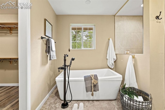 1308 Mesa Ave, Colorado Springs, CO 80906 - full bath featuring a spacious closet, a soaking tub, and baseboards