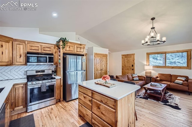 1978 High Chateau Rd, Florissant, CO 80816 - kitchen with appliances with stainless steel finishes, vaulted ceiling, light countertops, open floor plan, and light wood-type flooring