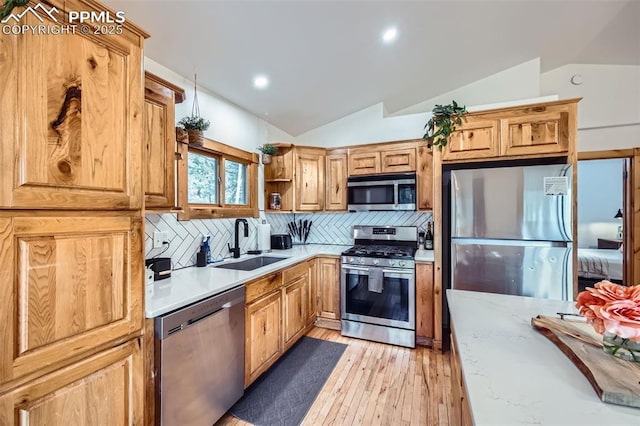 1978 High Chateau Rd, Florissant, CO 80816 - kitchen featuring stainless steel appliances, a sink, lofted ceiling, light wood-type flooring, and tasteful backsplash