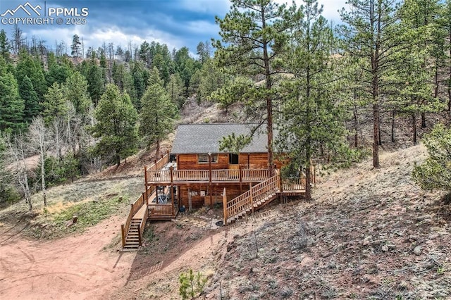 1978 High Chateau Rd, Florissant, CO 80816 - view of yard with stairway, a wooden deck, and a wooded view