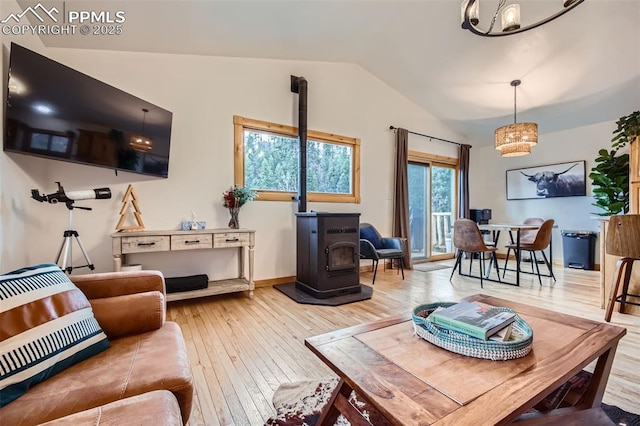 1978 High Chateau Rd, Florissant, CO 80816 - living area with a wood stove, a chandelier, hardwood / wood-style flooring, lofted ceiling, and heating unit