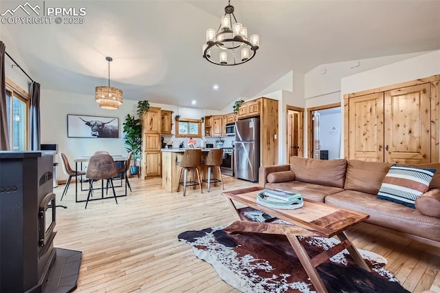 1978 High Chateau Rd, Florissant, CO 80816 - living area featuring a chandelier, lofted ceiling, and light wood finished floors