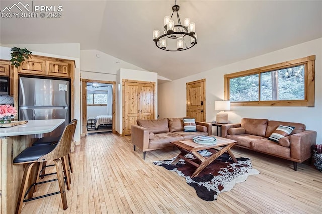 1978 High Chateau Rd, Florissant, CO 80816 - living area with vaulted ceiling, a chandelier, and light wood-style flooring