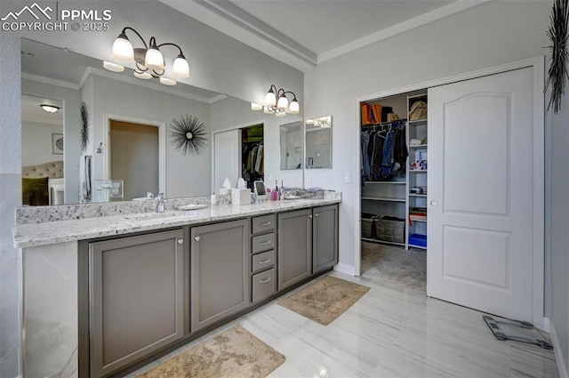full bathroom with a chandelier, ornamental molding, double vanity, and a spacious closet