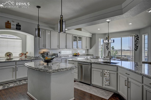kitchen with dishwasher, a sink, dark wood finished floors, a center island, and recessed lighting