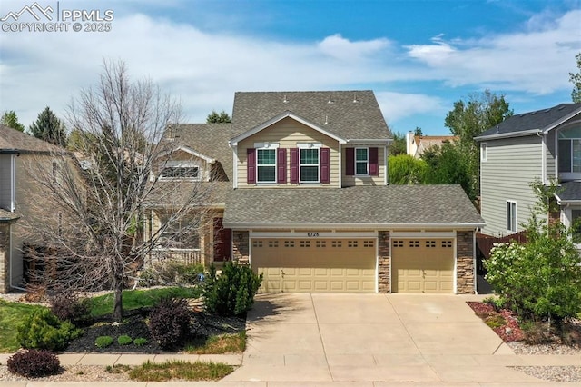 6726 Annanhill Pl, Colorado Springs, CO 80922 - view of front of property with concrete driveway, roof with shingles, stone siding, and an attached garage