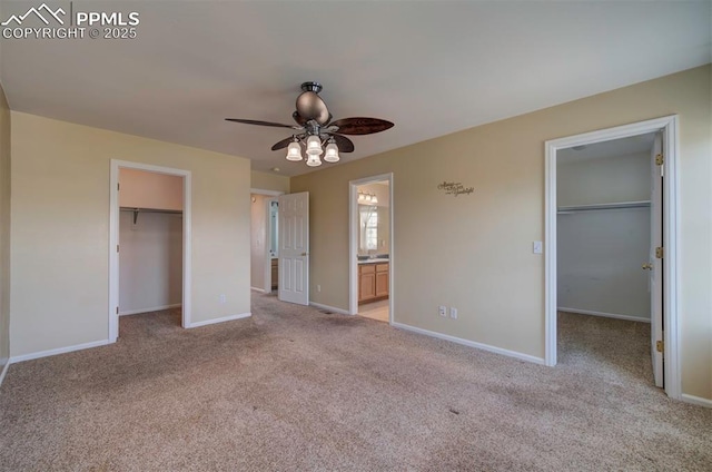 6726 Annanhill Pl, Colorado Springs, CO 80922 - unfurnished bedroom featuring a spacious closet, a closet, light carpet, baseboards, and connected bathroom