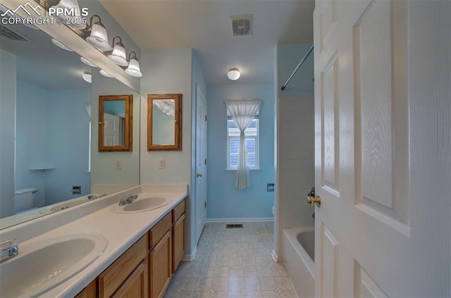 6726 Annanhill Pl, Colorado Springs, CO 80922 - bathroom with toilet, double vanity, and baseboards