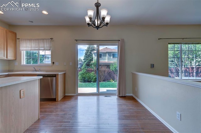 6726 Annanhill Pl, Colorado Springs, CO 80922 - kitchen featuring dishwasher, light countertops, hardwood / wood-style floors, a chandelier, and hanging light fixtures