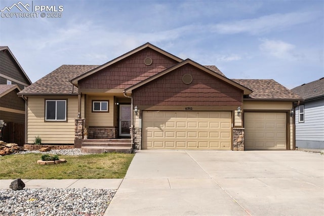 6752 Red Cardinal Loop, Colorado Springs, CO 80908 - craftsman-style house featuring a garage, concrete driveway, stone siding, and roof with shingles