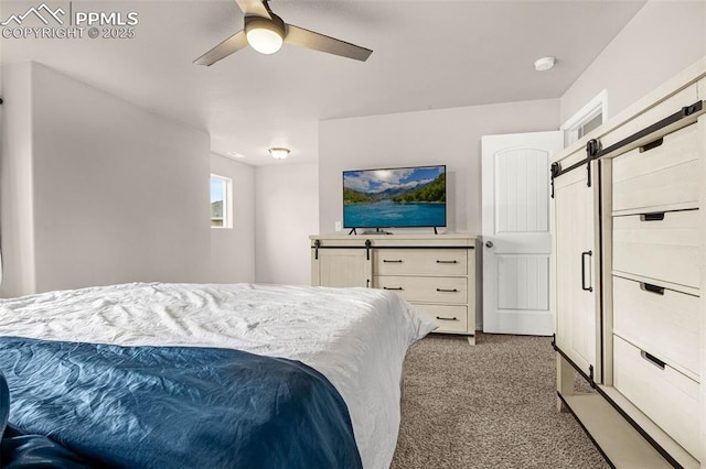 11081 Buckhead Pl, Fountain, CO 80817 - bedroom with a barn door, carpet, and ceiling fan