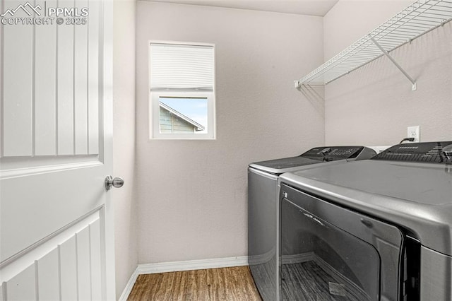 11081 Buckhead Pl, Fountain, CO 80817 - laundry room featuring washer and clothes dryer, baseboards, and wood finished floors