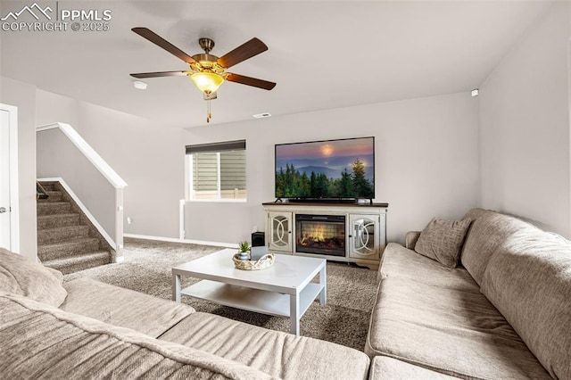 11081 Buckhead Pl, Fountain, CO 80817 - living room featuring carpet, stairway, a ceiling fan, baseboards, and a glass covered fireplace